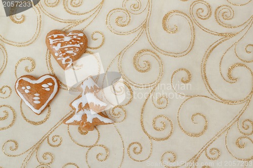 Image of homemade gingerbreads on christmas background