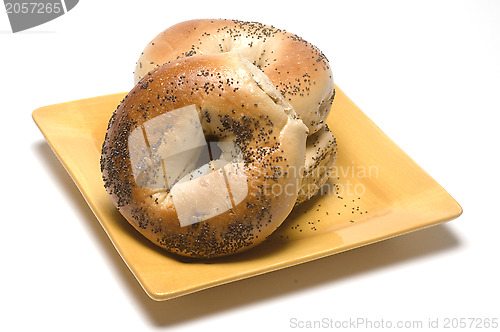 Image of fresh baked poppy seed bagels on plate 