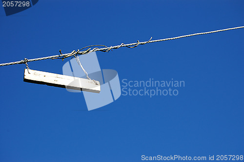 Image of Plain white sign against a blue sky