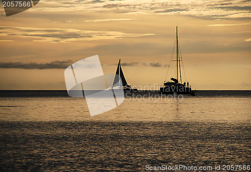 Image of Sailing vessels silhouetted at sundown