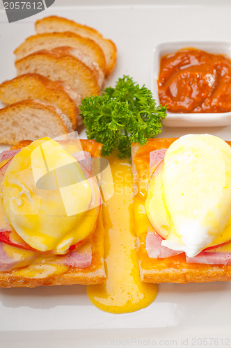 Image of eggs benedict on bread with tomato and ham