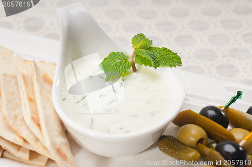 Image of Greek Tzatziki yogurt dip and pita bread