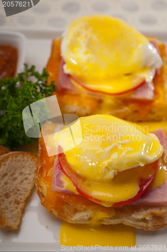 Image of eggs benedict on bread with tomato and ham