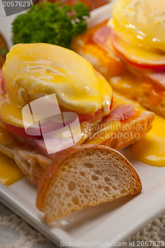 Image of eggs benedict on bread with tomato and ham