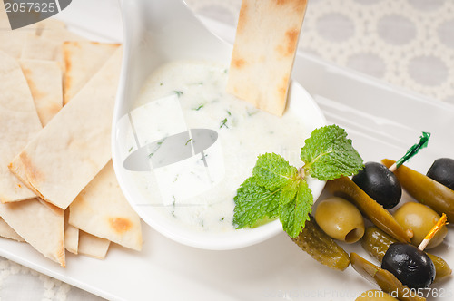 Image of Greek Tzatziki yogurt dip and pita bread