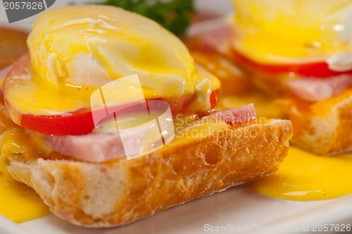 Image of eggs benedict on bread with tomato and ham