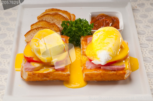 Image of eggs benedict on bread with tomato and ham