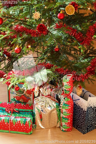 Image of detail of gifts under decorated christmas tree