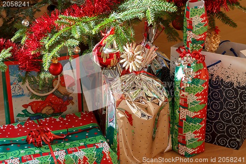 Image of detail of gifts under decorated christmas tree