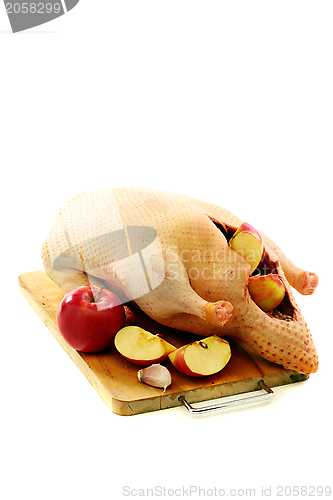 Image of Raw duck with apples.