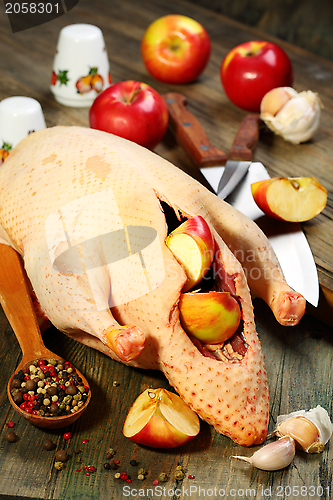 Image of Raw duck, apples, garlic and pepper.