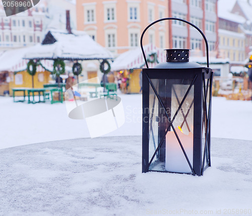 Image of Lantern on a table on a background of the Christmas market
