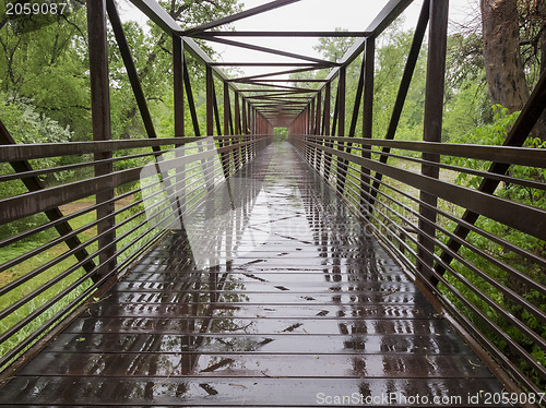 Image of wet bike trail bridge