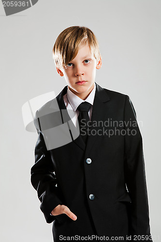 Image of Serious young boy in black suit