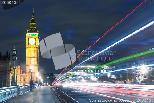 Image of Tower Bridge in London, UK at night with traffic and moving red 