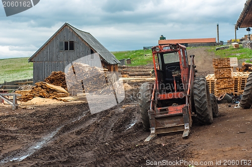 Image of Wood industry outdoorsm with red tractor