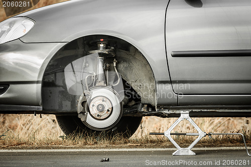 Image of Car without tire on the road