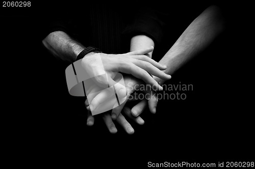 Image of Group of young adults making a pile of hands