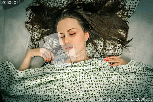 Image of Young woman in the bed