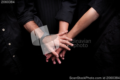 Image of Group of young adults making a pile of hands