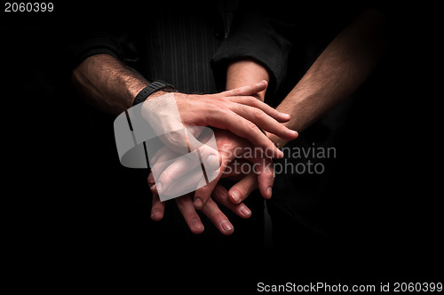 Image of Group of young adults making a pile of hands