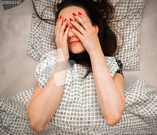 Image of Young woman in the bed