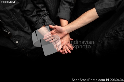 Image of Group of young adults making a pile of hands