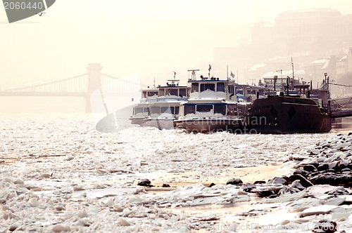 Image of Big boats stuck in the ice at winter