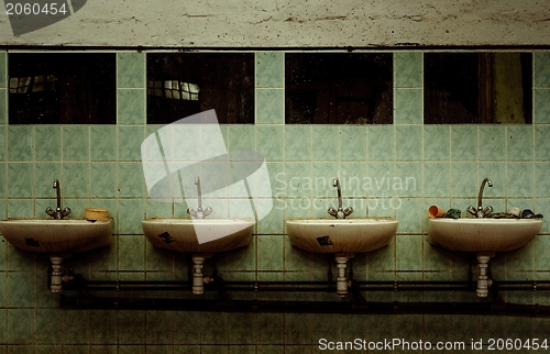 Image of An abandoned industrial interior with a depressed man