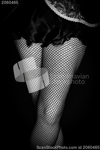 Image of Legs of a youn woman against dark background