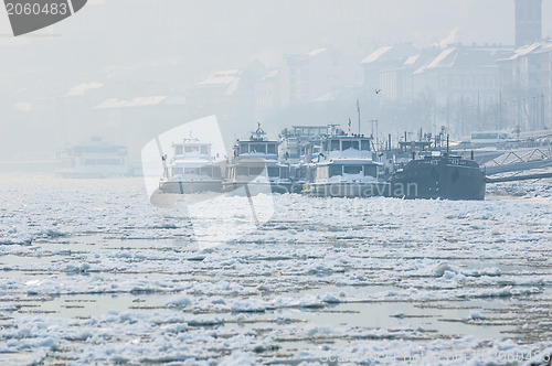 Image of Big boats stuck in the ice at winter