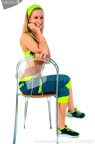 Image of Young fitness instructor sitting on chair