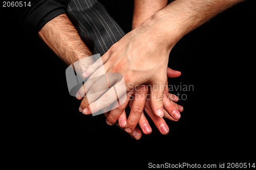 Image of Group of young adults making a pile of hands