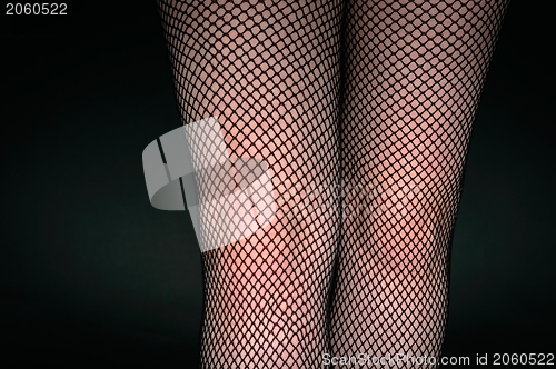 Image of Legs of a youn woman against dark background