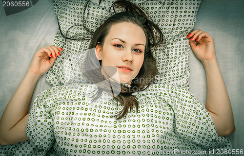 Image of Young woman in the bed