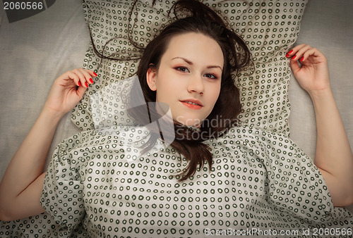 Image of Young woman in the bed