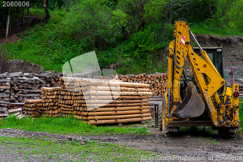 Image of Construction machine and a pile of boards