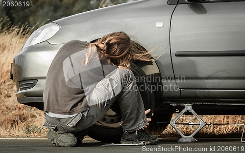 Image of Young man repairing the car