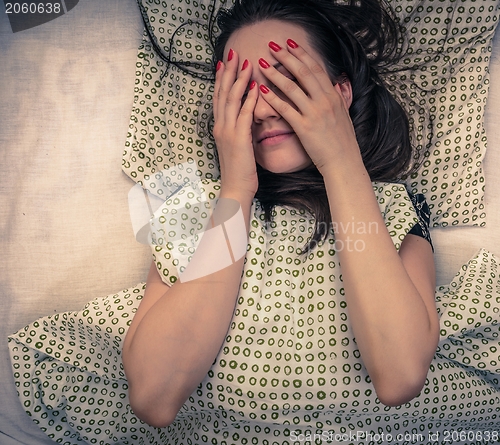 Image of Young woman in the bed