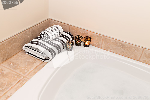 Image of Towels, candle lights and bath with foam