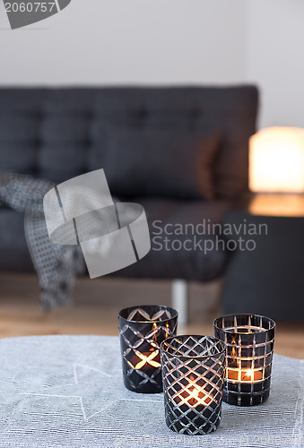 Image of Tea-lights decorating living room with gray sofa