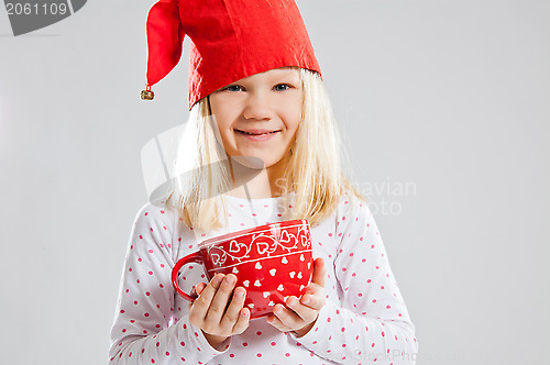 Image of Smiling young girl holding big red cup