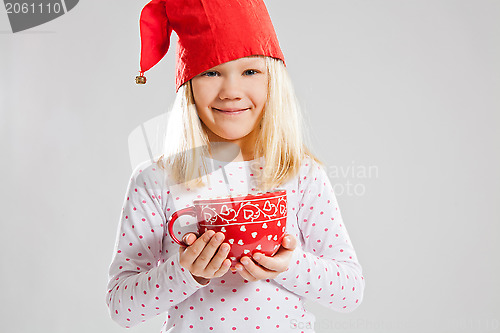 Image of Smiling young girl holding big red cup