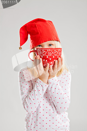 Image of Smiling young girl holding big red cup