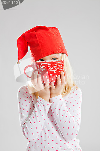 Image of Smiling young girl holding big red cup