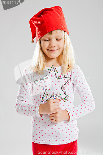 Image of Happy young girl holding Christmas star decoration