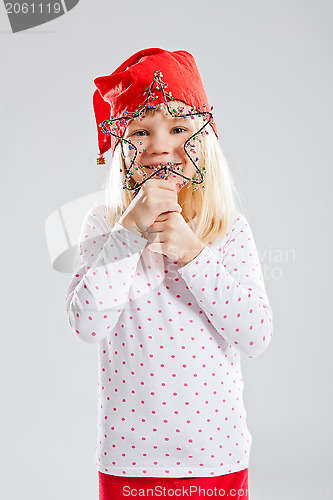 Image of Happy young girl holding Christmas star decoration