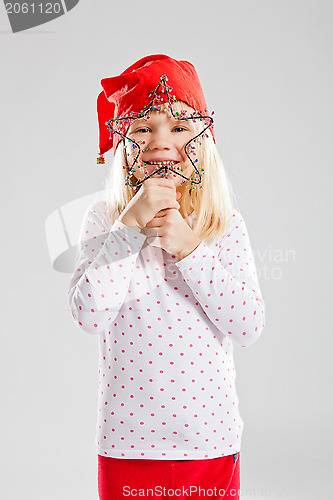 Image of Happy young girl holding Christmas star decoration