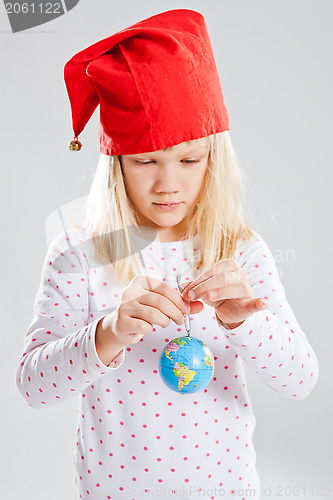 Image of Young girl holding world in hands