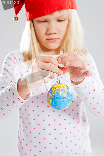 Image of Young girl holding world in hands